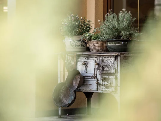 Wiesenhof in Pertisau: the Entner family and team Old stove with pots and potted plants on a patio