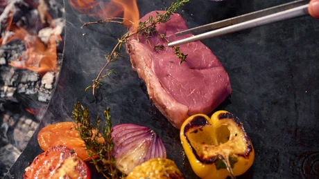 Wiesenhof from all perspectives Steak and vegetables grilling on a hot grill plate with open flames