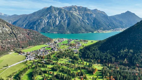 Wiesenhof from all perspectives View of lake and mountain village surrounded by forests and mountains