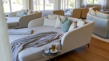 Wiesenhof from all perspectives Modern cozy lounge area with sofas, cushions, and drinks by the window