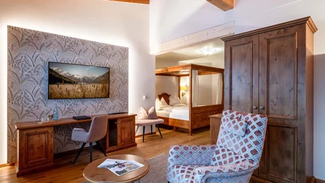 Wiesenhof from all perspectives Cozy hotel room with wooden furniture and a TV mounted on the wall