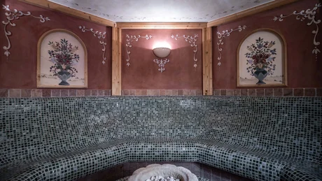 Wiesenhof from all perspectives Tiled seating area with floral wall paintings and wall light