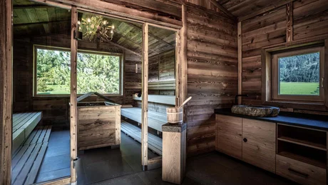 Wiesenhof from all perspectives Wooden sauna with panoramic window overlooking green landscape