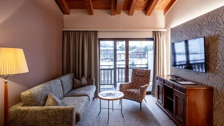 Wiesenhof from all perspectives Cozy living room with sofa, armchair, TV and mountain view through glass door