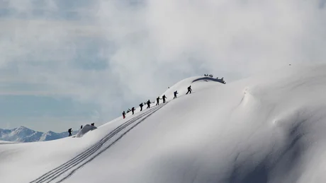 Wiesenhof from all perspectives Group of hikers trekking on snowy mountain ridge under clear sky