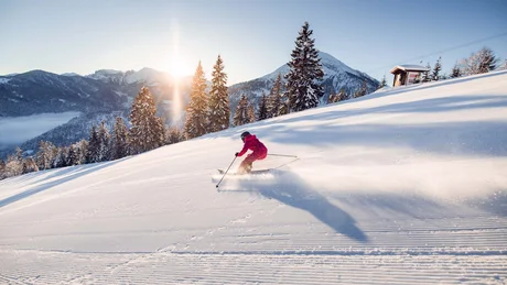 Wiesenhof from all perspectives Skier skiing on freshly groomed slope under bright sun